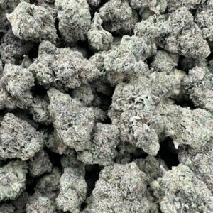 Zlushie strain top-shelf flower with refined trichome frosting creating silvery-white crystal coating across premium curated buds